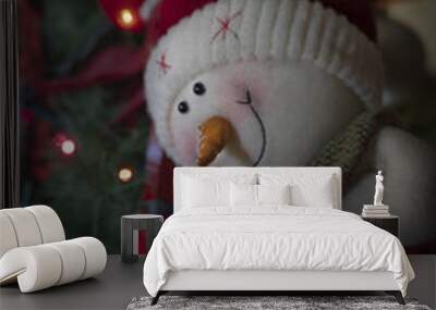 Cute snowman toy on the decorated Christmas tree backgrou Wall mural