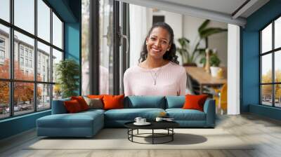 Cheerful beautiful African woman professional standing at home in office looking at camera. Happy confident entrepreneur lady laughing face posing alone, head shot close up view portrait Wall mural