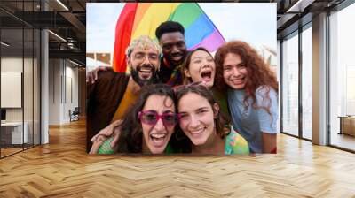 Diverse group of happy young people taking funny vertical selfie for social media celebrating gay pride festival day. Lgbt community concept cheerful friends outdoors. Generation z enjoy party. Wall mural