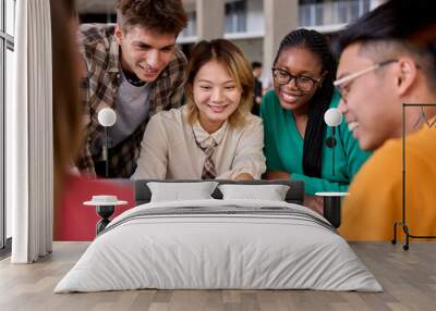 Group of diverse multiethnic smiling young students using laptop studying gathering in classroom. Academics multiracial people classmates working in a project creative inside of university building Wall mural