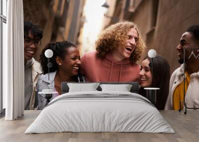 group of happy friends having fun together outdoors. mixed race people laughing making community. Wall mural