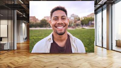 Handsome happy African American bearded man. Portrait of cheerful young man standing outdoors and smiling at camera. Positive emotion concept of male person. Generation z guy look carefree and natural Wall mural