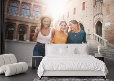 Happy women having fun together in Venice. Three young women, multiracial group, hugging and laughing together - Best friends sharing happiness, lifestyle and friendship concepts Wall mural