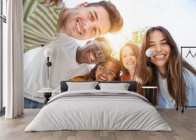 Happy Young friends looking camera and laughing. Smiling Group of people having fun together outdoors. Cheerful community of students university. Modern lifestyle of multicultural people joyful. Wall mural