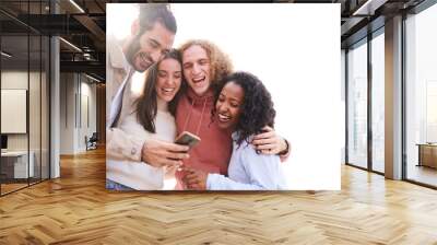 Isolated copy space white background. Four cheerful friends watching smartphone outdoors. People using digital device and sharing in social media togethers. Wall mural