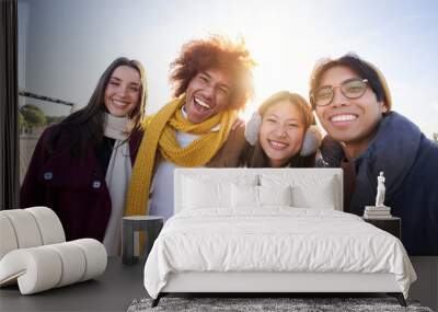 Portrait of Mixed race group of happy colleagues looking at camera and having fun in winter clothes. Young smiling people laughing together enjoy the community. Cheerful face of young students Wall mural