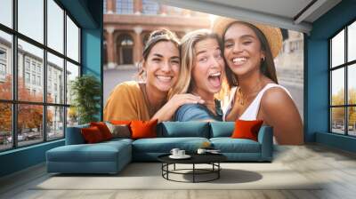 Three cheerful girls friends in summer clothes taking a selfie outdoors at the touristic urban center city. High quality photo Wall mural