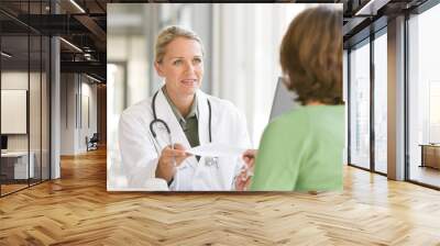 attractive young caring doctor talking to patient Wall mural