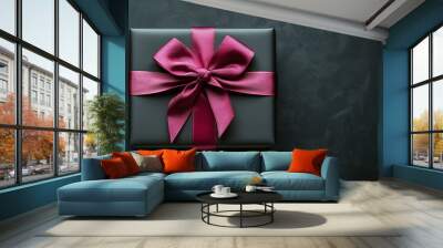 Flat lay of black gift box with pink ribbon on black background, black friday shopping, copy space Wall mural