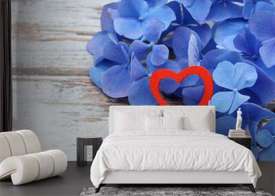 blue flower and red heart lying on wood Wall mural