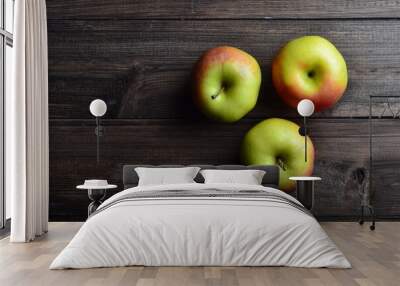 three red apples on brown rustic wooden background, top view, copy space Wall mural