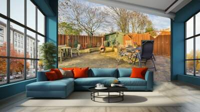 a backyard area with chairs, tables and an outdoor dining set up in the middle part of the back yard Wall mural