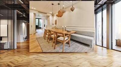 a dining room with wood flooring and white trim on the walls there is a wooden table that has two chairs in it Wall mural