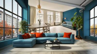 a living room with blue walls and hardwood flooring, including a wooden dining table surrounded by two planters Wall mural