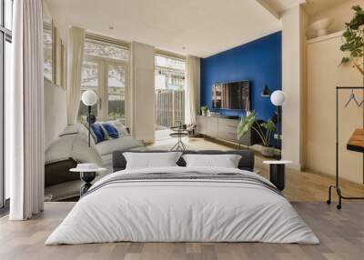 a living room with blue walls and white trim on the walls, hardwood flooring in the center of the room Wall mural