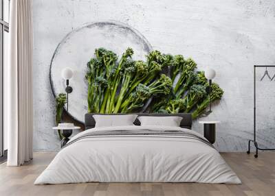 Broccolini, broccoli florets green vegetable broccolini grows baby broccoli vegan food grey table overhead Wall mural