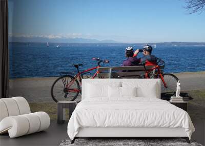 Bike riders relax at a park Wall mural