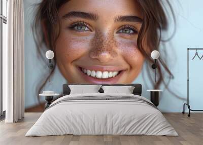 closeup portrait of beautiful young brunette woman with green eyes white smile and freckles Wall mural