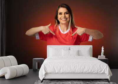 woman soccer fan cheering for her favorite club and team. world cup red background Wall mural