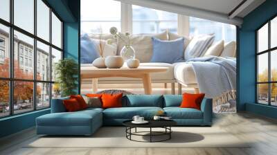 A living room with a white couch, a coffee table, and a blue throw blanket Wall mural