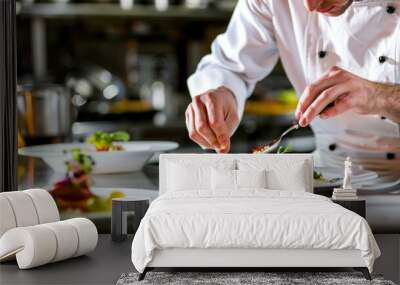 Professional chef carefully garnishing a dish with fresh herbs in a restaurant kitchen. Wall mural