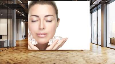 Beauty Skin care Treatments. Spa Woman with healthy clean skin aplying ice cubes on face. Wall mural