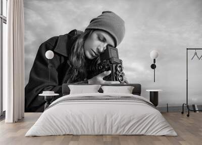 Lifestyle Portrait. Young Female Photographer Using Vintage Camera Wall mural