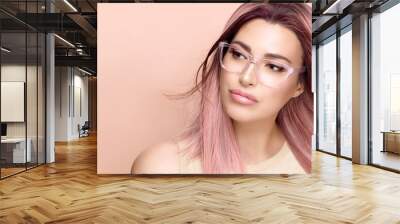 women eyewear. beautiful young woman in clear glasses and fashionable colored pink hair, sexy lips a Wall mural