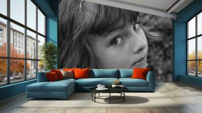 Black and white portrait of a young girl looking over her shoulder Wall mural