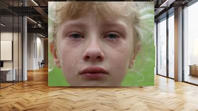 Closeup of a young girl with tears rolling down her cheek Wall mural