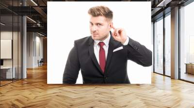 Handsome business man showing not hearing gesture Wall mural