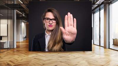 Serious businesswoman gesturing stop sign Wall mural