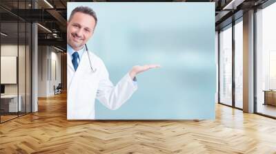 Young positive medic holding something in his palm Wall mural