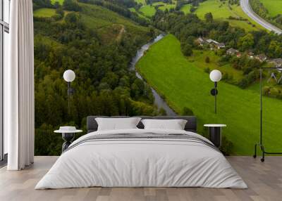 Small river in a green rural landscape; aerial view Wall mural