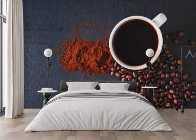 Hot coffee with coffee powder and coffee beans on a black background Wall mural