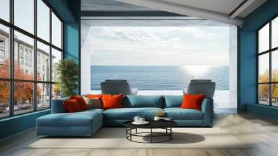 Terrace with sea and beach view. Attic and empty room with modern interior design. Gray concrete space with two chaise lounges for relaxing. Wall mural