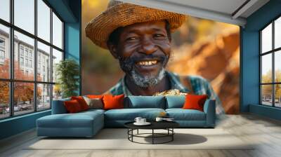 South African gold miner holding a large shiny gold nugget and celebrating his find, portrait, close-up Wall mural