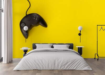 Black console gamepad of video game on yellow background. concept of fun and strategy. Wall mural