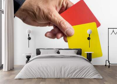 A male football (soccer) referee's hand holding yellow and red cards, isolated on a white background Wall mural