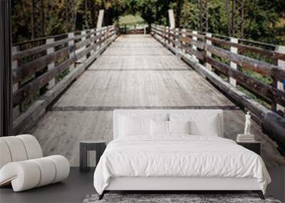 Old wooden and steel bridge across a river Wall mural