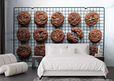 Overhead view of salted dark chocolate cookies on wire cooling rack. Wall mural