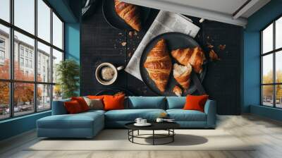 Plates of croissants with coffee and jam on black table from above. Wall mural