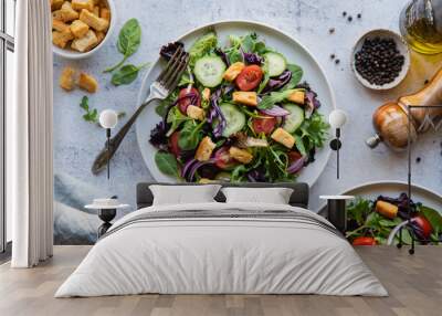 Top view of salads with lettuce, tomatoes and cucumbers on two plates. Wall mural