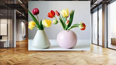 yellow, red and purple tulips in a vase against the white backgr Wall mural