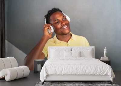 young african man smiling while listening to music Wall mural