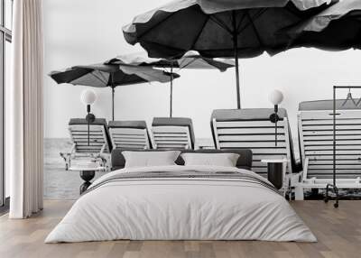 empty sun chair and umbrella on beach in black and white  Wall mural