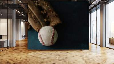 baseball and glove on dark moody background. Wall mural