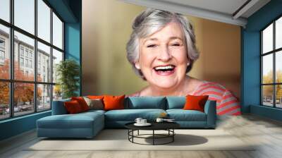 Portrait, nursing home and happy senior woman in living room, laughing in house or relax in retirement. Elderly lady, happiness and healthy person laughing at funny, joke or freedom of retired life Wall mural