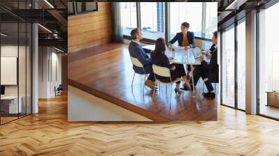 Professional, group and meeting for a discussion or collaboration at a company with a plan. Teamwork, conversation and strategy at a table for a project or partnership with tech at the office. Wall mural