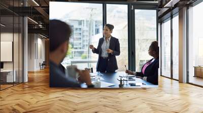 Ironing out the details. Shot of corporate businesspeople meeting in the boardroom. Wall mural